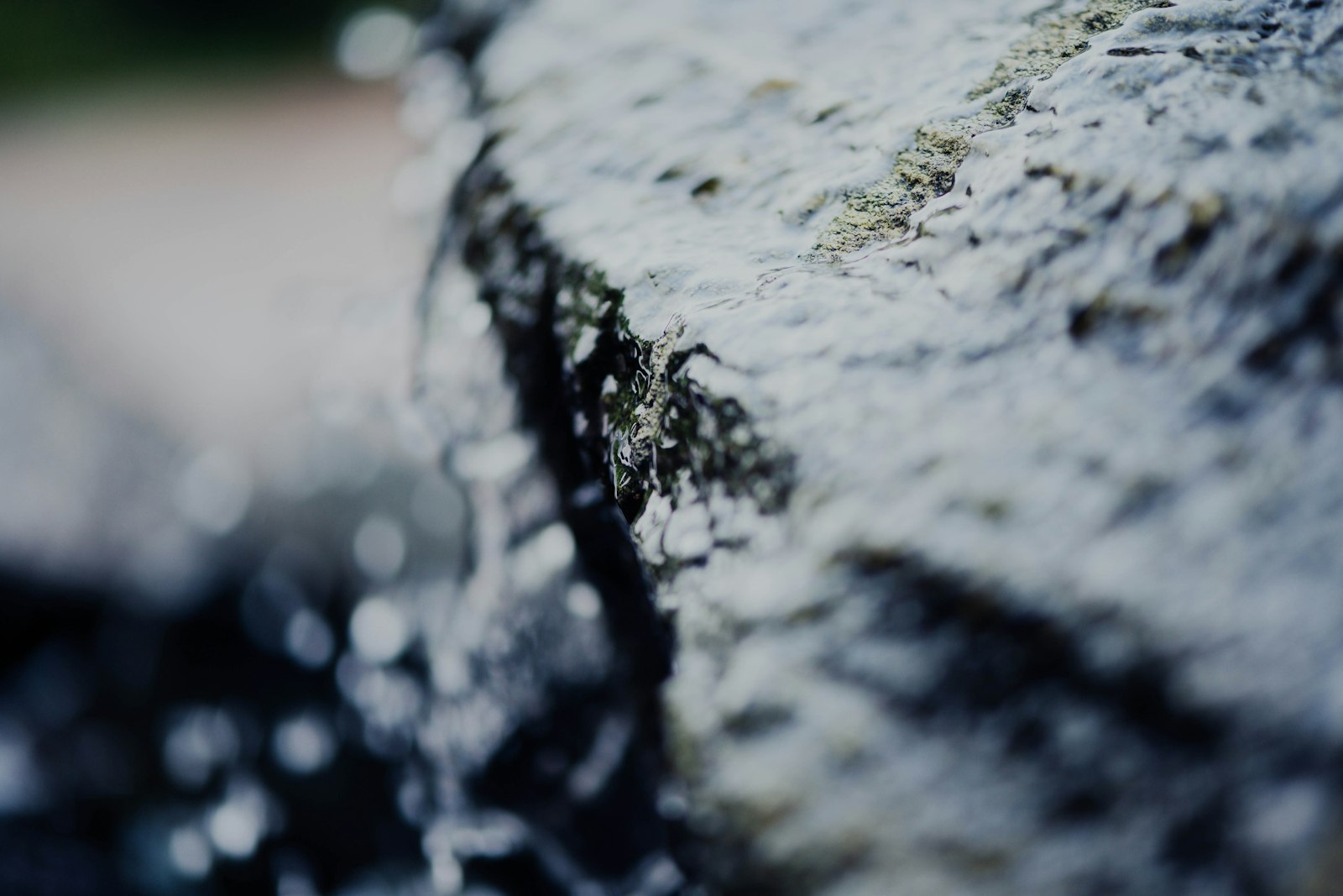 a close up of a rock with water coming out of it